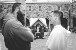 A Franciscan and Dominican brother converse outside the courtyard of the Monastery of St. Dominic, for the Cloistered Nuns of the Order of Preachers, in Newark