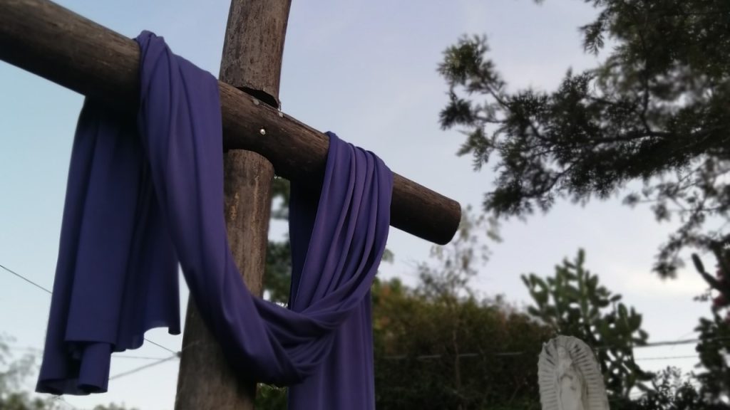 A Lenten image of a crucifix draped with a purple cloth